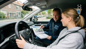 Driving instructor gives explanation during automatic driving lesson in Amsterdam West
